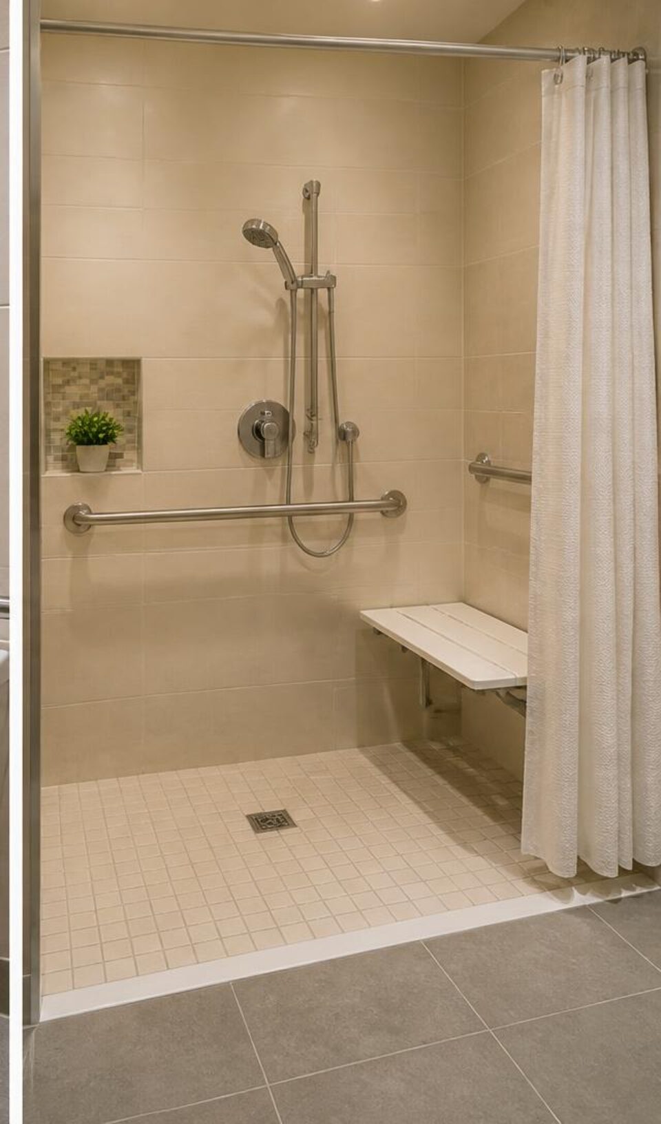 Roll-in shower with seat, grab bars, and reachable handheld shower